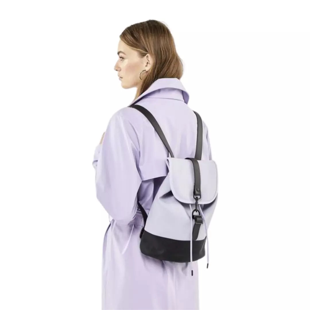 Rains waterproof drawstring backpack lavender worn by woman