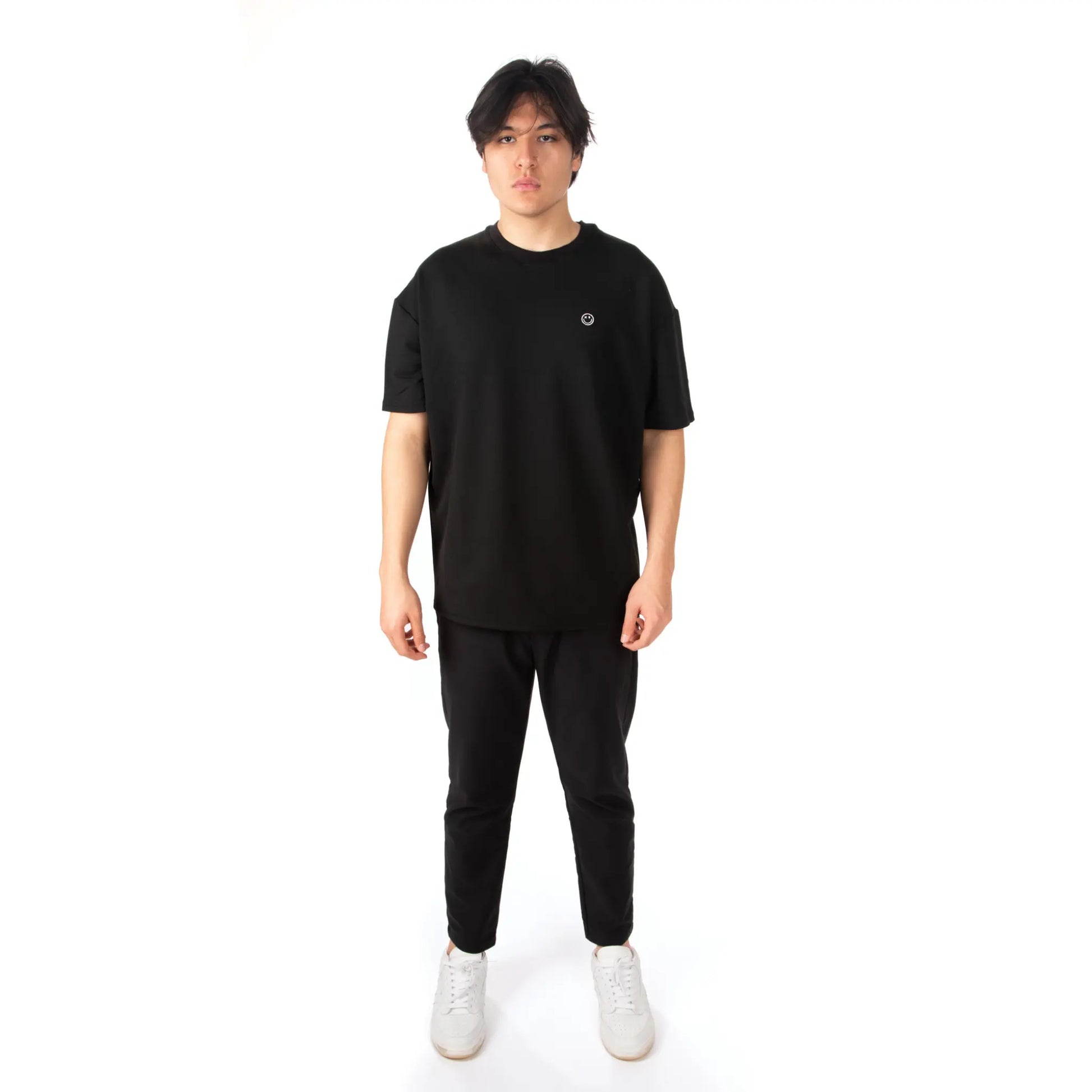 Unisex Oversized Black T-shirt Nous Sommes Catastrophiques front view on male model