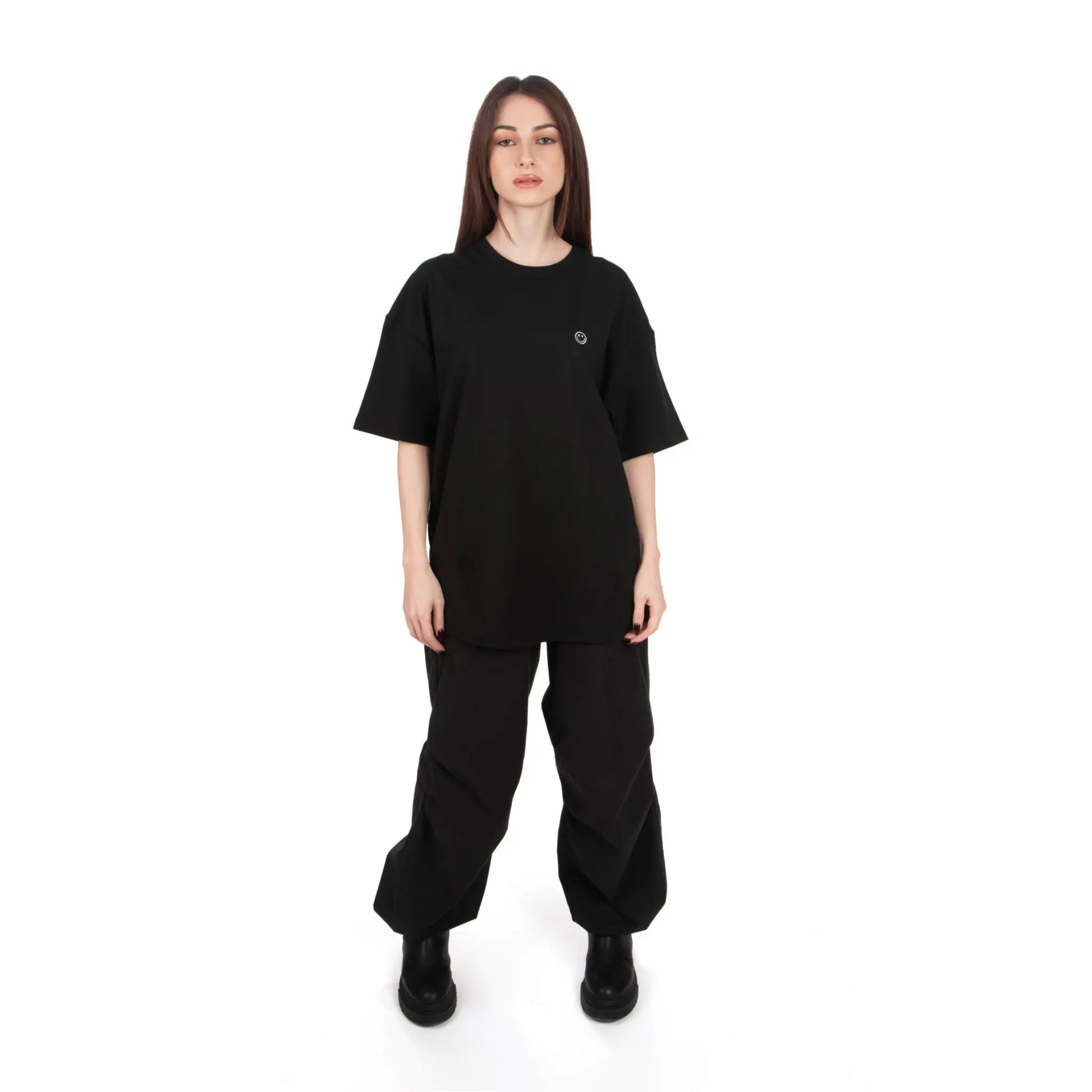 Unisex Oversized Black T-shirt Nous Sommes Catastrophiques front view on female model