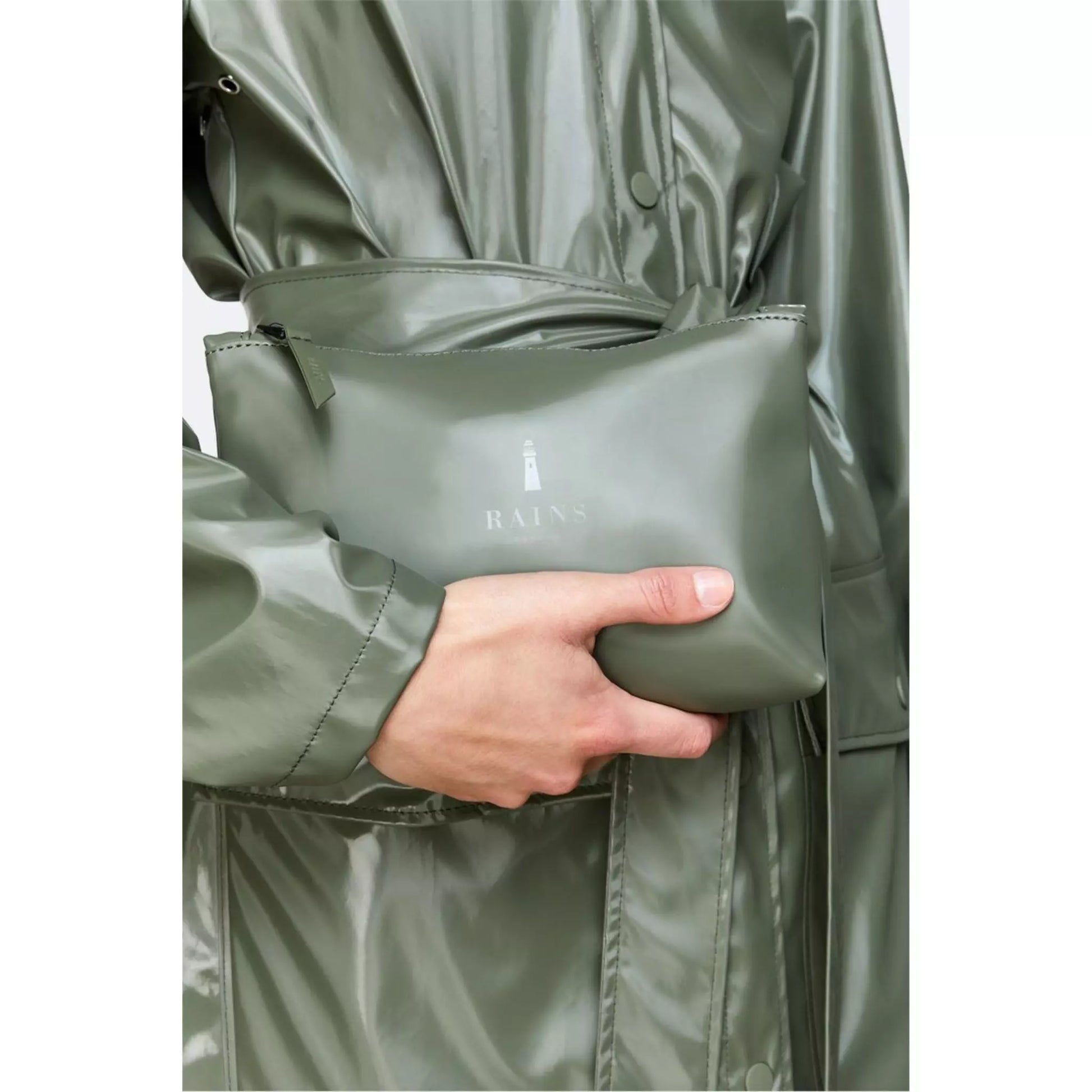 Rains waterproof cosmetic bag green held by men