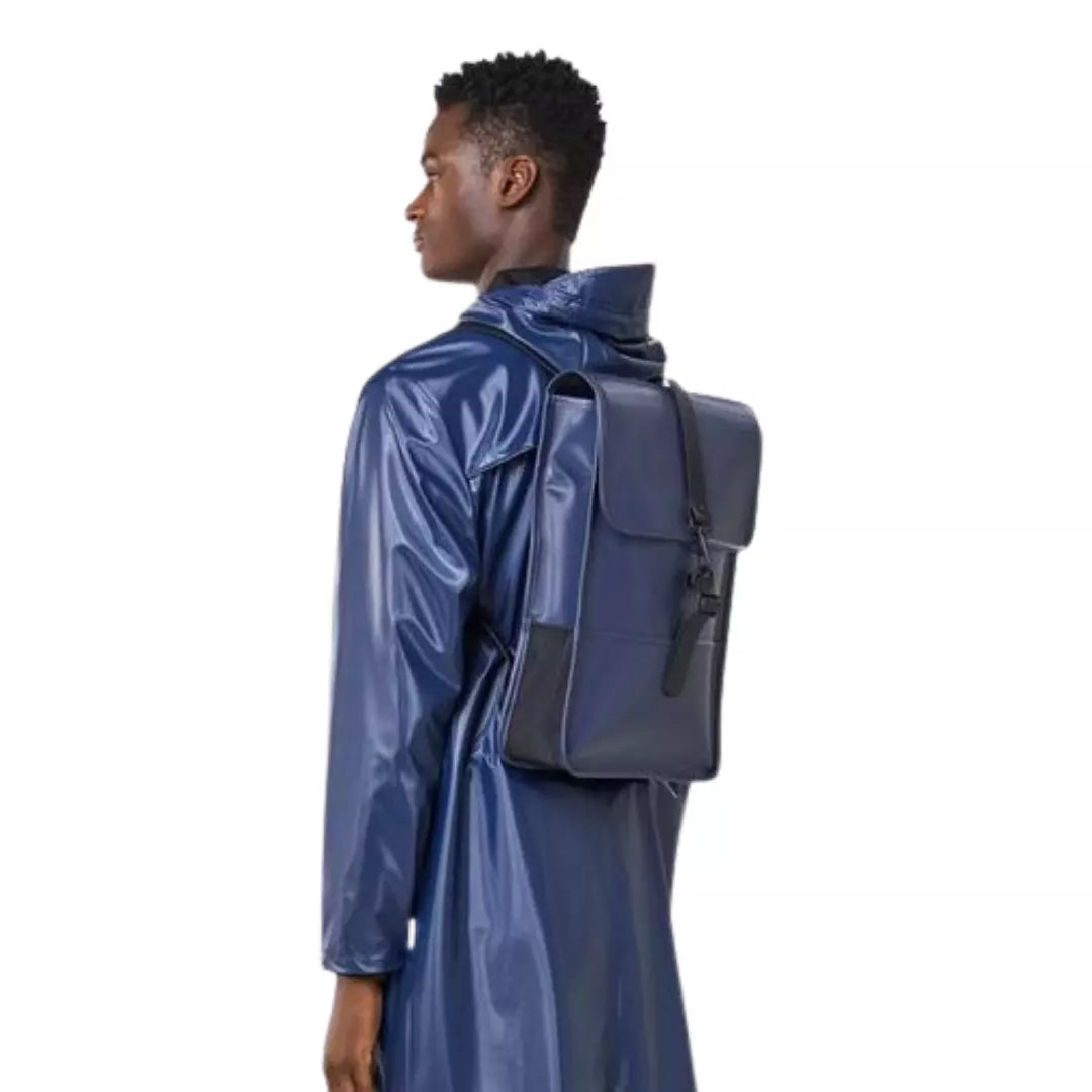 Rains waterproof backpack mini shiny blue worn by men