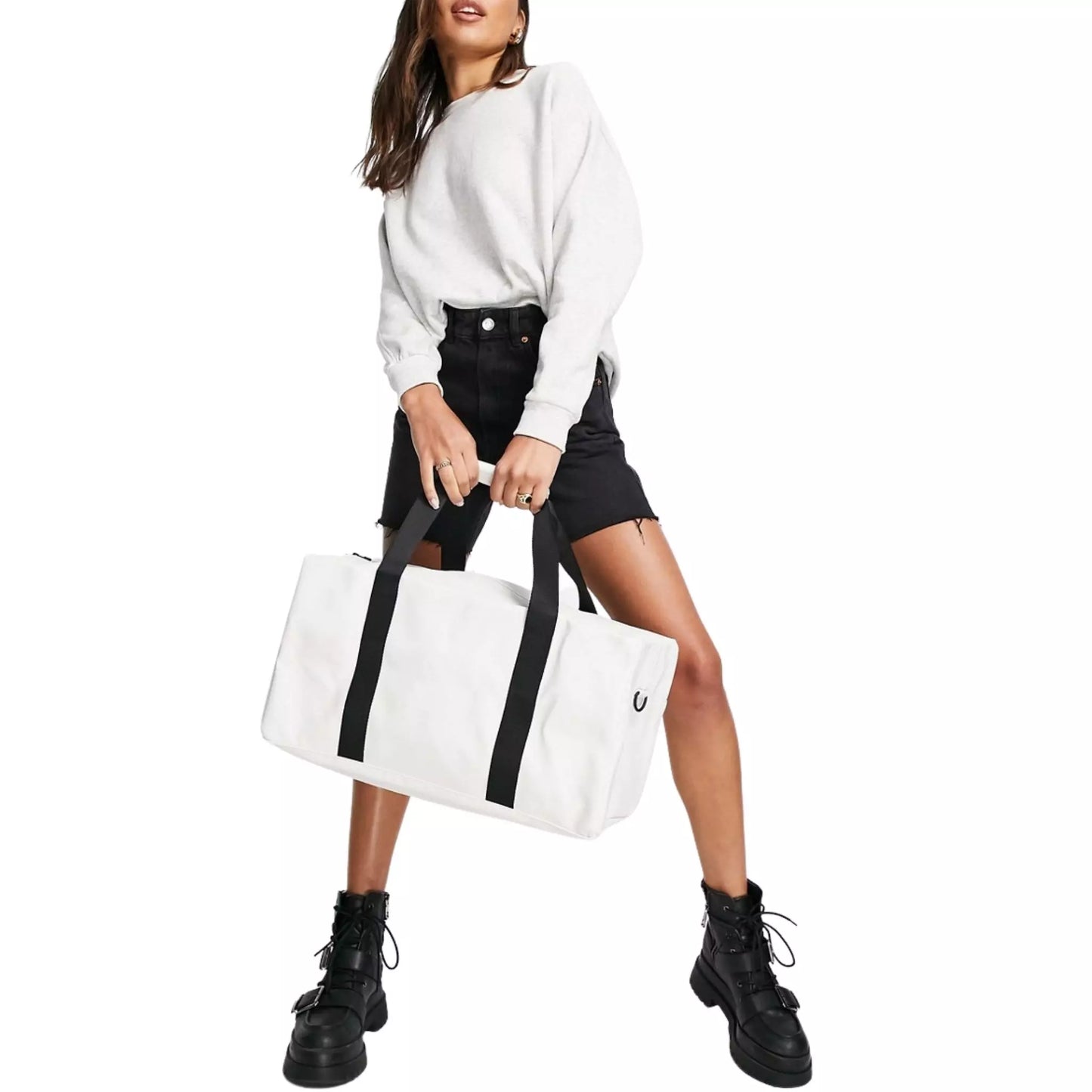 Rains waterproof gym bag off white held by two hands of a woman on the front