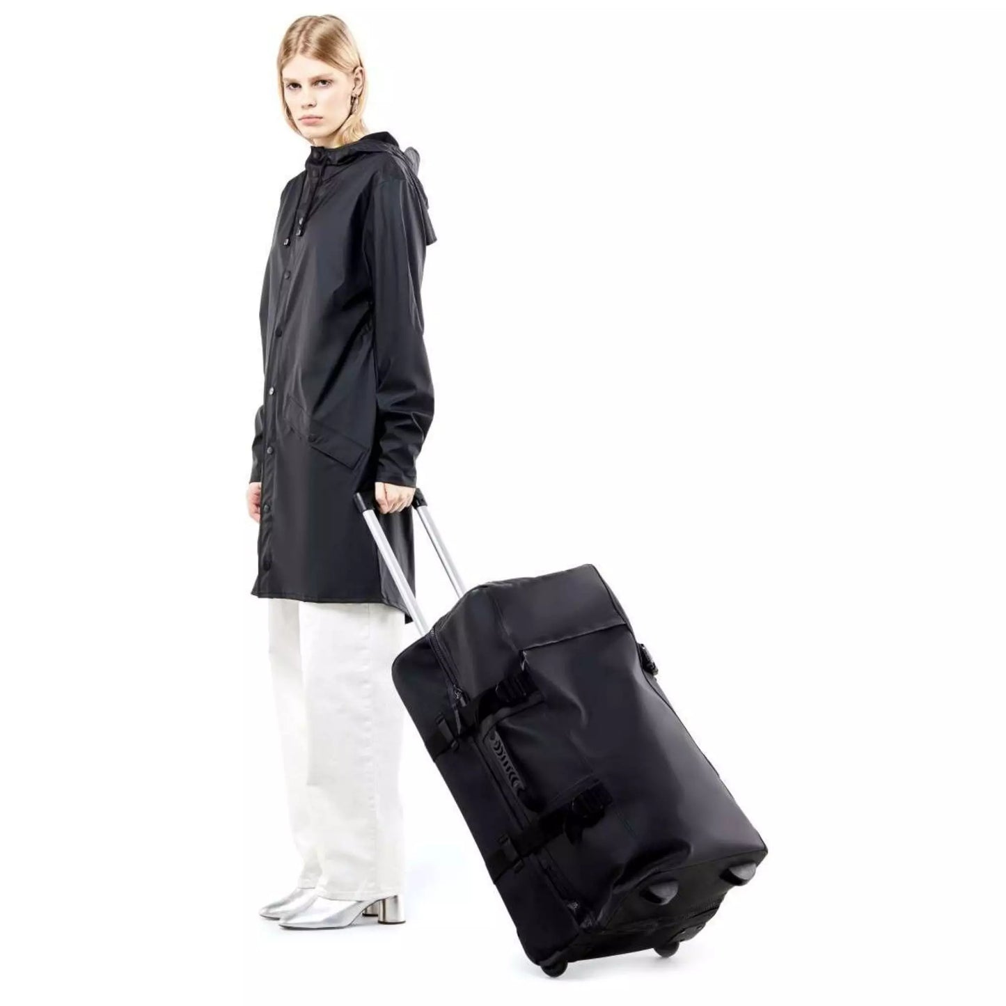 Rains waterproof travel bag large black held by a woman